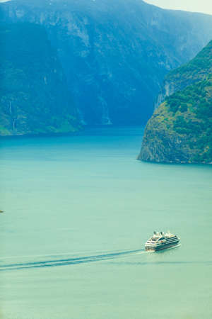 Tourism and travel. Mountains landscape and cruise liner ship sailing on the fjord, Norway Scandinavia.の写真素材
