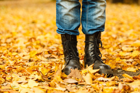 Nature outdoor foliage relax concept. Man in black boots.  Male in leather footwear jeans trousers...