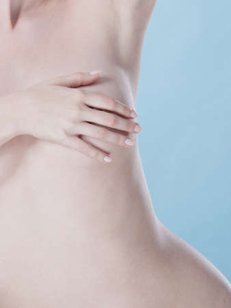 Health care medical concept. Close up young woman examining her breasts for lumps or signs of breast cancerの写真素材
