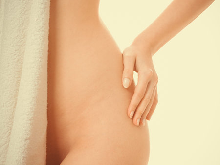 Sensuality and sexuality of women. Perfect female part body covered by bath towel. Seductive woman...