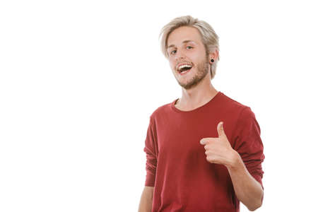 Success concept. Young college student giving thumb up hand sign gesture, isolated on whiteの写真素材