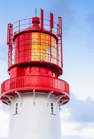 Historic red white lighthouse on the edge of rocky sea coast, South Norway, Lindesnes Fyr beaconの写真素材
