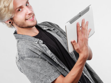 Education social media. Modern technology internet concept. Stylish handsome young man using tablet...