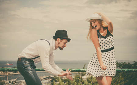 Summer holidays love relationship and dating concept - romantic playful couple retro style flirting outdoorの写真素材