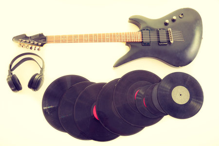 Equipment of musician. Electric electro black guitar string intrument big headphones and vinyl...