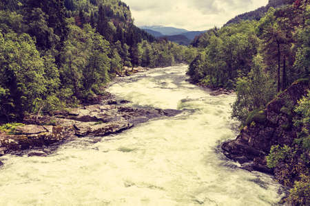 The rapidly flowing Stranda river winding through mountains, beautuful canyon in Norway.の写真素材