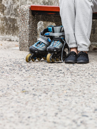 Closeup of woman girl with roller skates blades outdoor.