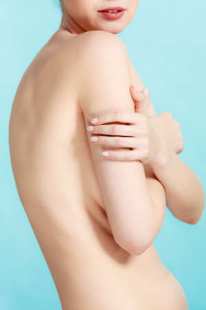 Beauty female slim figure, body care concept. Attractive naked sensual woman covering her breast with hands. Pertect clean soft skinの写真素材