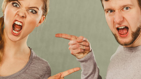 Bad relationship and divorce. Expressive young couple yelling shouting. Husband and wife having big...