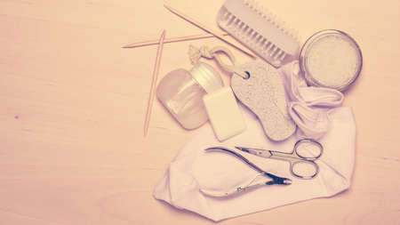 Foot care. Pedicure accessories set tools on wooden board background top view with copy spaceの写真素材