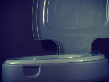 Open portable toilet bowl on gray backgroundの写真素材