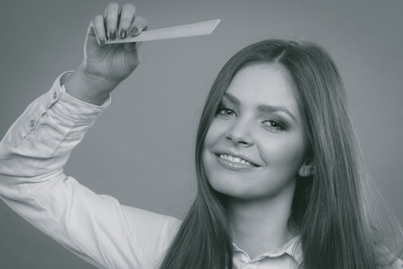 Care coiffure haidressing professional beauty concept. Girl with comb. Young smiling lady combing hairs changing haistyle.の写真素材