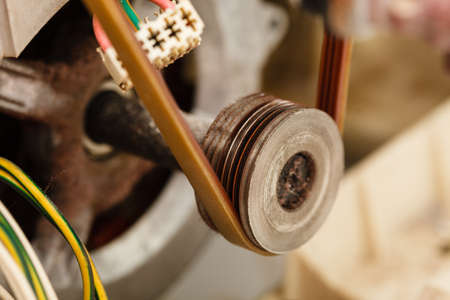 Repair mechanical industrial domestic concept. Insides of broken device. Internal parts of wasching machine exposed.の写真素材