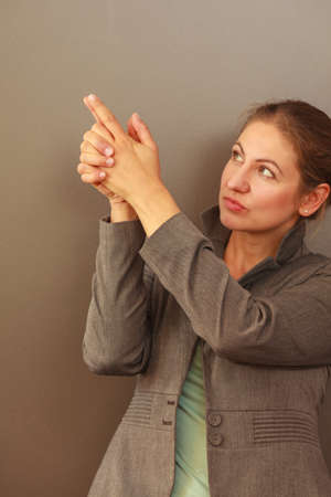 Advertisement idea. Mature business woman assistant manager showing copy space. Adult female wearing stylish jacket elegant outfit. Office work and corporation concept.の写真素材