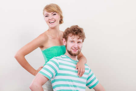 Cheerful young couple portrait blonde girl and bearded guy on gray background,の写真素材
