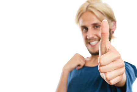Success concept. Young college student giving thumb up hand sign gesture, isolated on white