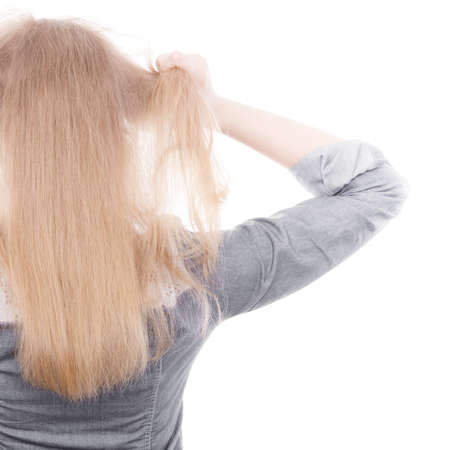 Fury and big anger inside of people. Blonde furious woman pulling blonde hair out of head. Emotional young girl showing her bad expression.の写真素材