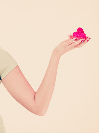 Sweets, junk food, sugar temptation on diet concept. Woman holding sweet delicious cupcakeの写真素材