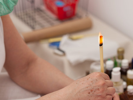 Terapist doing ear candling, Alternative therapy session, natural medicine, health care.の写真素材