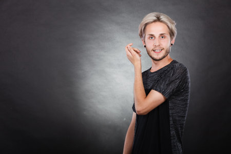 Happy young man portrait, stylish bearded male smiling, on dark