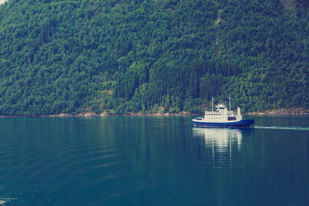 Tourism vacation and travel. Mountains landscape and ferryboat sailing on fjord in Norway Scandinavia Europe. Norddalsfjorden as seen from ferry. Beautiful natureの写真素材