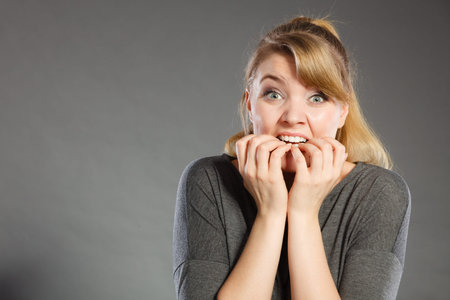 Frustration mental disorder psychology fear stress concept. Nervous girl biting nails. Stressed...