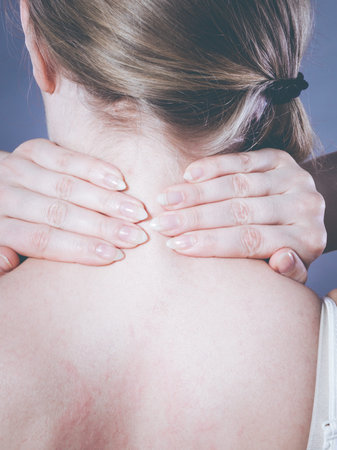 Feeling exhausted, back and spine disease. Woman having bad ache. Female placing hands on her neck...