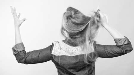 Fury and big anger inside of people. Blonde furious woman pulling blonde hair out of head. Emotional young girl showing her bad expression.の写真素材