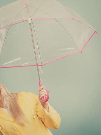 Rainy autumn day accessories ideas concept. Woman hand holding clear transparent umbrellaの写真素材