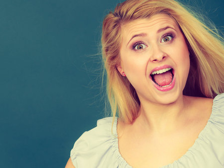 Happiness human face expressions concept. Happy positive cheerful smiling woman having funny expressionの写真素材