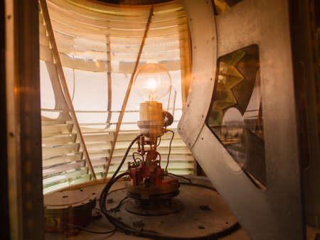 Closeup inside of old lighthouse showing the light bulb interior.の写真素材