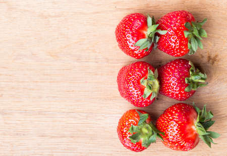 Healthy nutrition diet. Red fresh strawberry fruits on wooden table board copy space text areaの写真素材