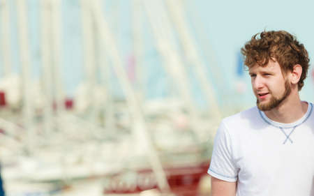 Travel tourism and people concept. Hipster bearded man in marina against yachts in portの写真素材