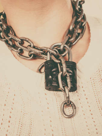 Sore throat, tonsillitis, health problems, lack of freedom concept. Woman having metal chain around neckの写真素材