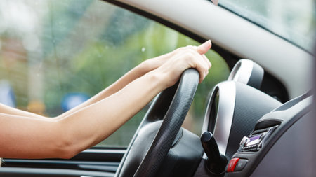 Summer road trip, travel freedom concept. woman sit in car indoor keeps wheel, female ready for the...