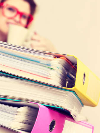 Happy woman at office drinking hot coffee or tea enjoying her break time during work. Job relax.の写真素材