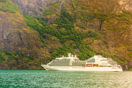 Tourism and travel. Mountains landscape and cruise liner ship sailing on the fjord, Norway Scandinavia.の写真素材