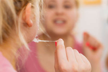 Skincare concept. Young blonde woman removing peel off mask from her face.の写真素材