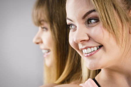 Friendship, human relations concept. Two happy women friends having fun smiling with joyの写真素材