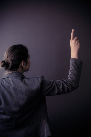 Advertisement idea. Mature business woman assistant manager showing copy space. Rear view of adult...