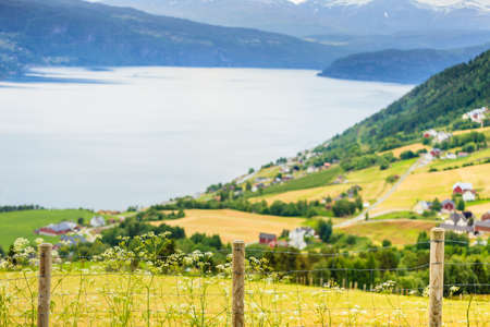 Norwegian country house in the mountains on sea shore. Beautiful coastline fjords landscape and village, Scandinavia Europeの写真素材