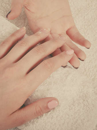 Woman hand on towel, waiting for gel hybrid manicure. Beauty wellness spa treatment conceptの写真素材