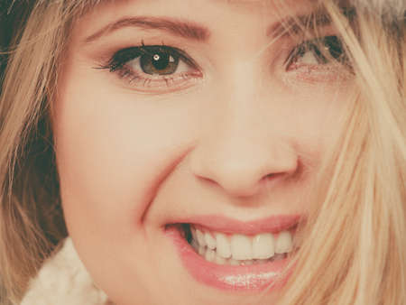 Close up of beautiful young blonde woman face having happy positive expression.の写真素材