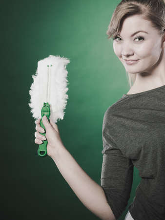 Household duties concept. Young energy girl playing with cleaning cloth doing domestic chores. Cheerful playful housewife ready to clean house.のeditorial素材