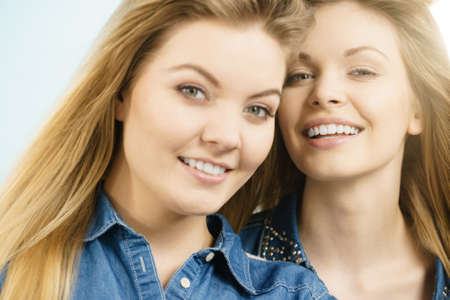 Friendship, human relations concept. Two happy women friends having fun smiling with joyの写真素材