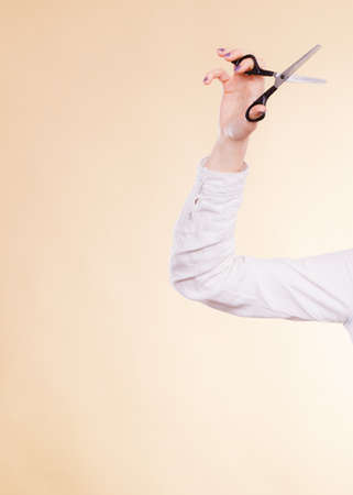 Equipment of barber. Hand of female hairdresser hairstylist with scissors trimmers. Time to cut hair.の写真素材