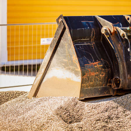 Detailed close up of excavator shovel in heavy industrial machine in sand.の写真素材