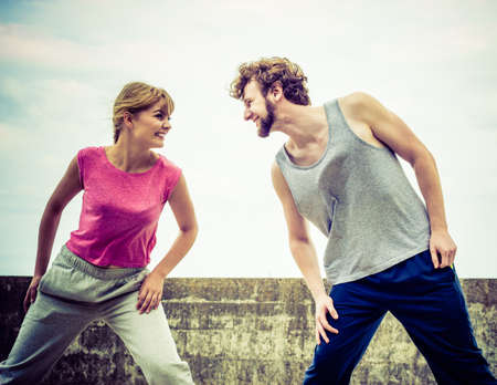 Outdoors activities sport and hobby. Exercises for healthy and strong body. Friends stretch together have fun outdoors wearing sportswear.の写真素材