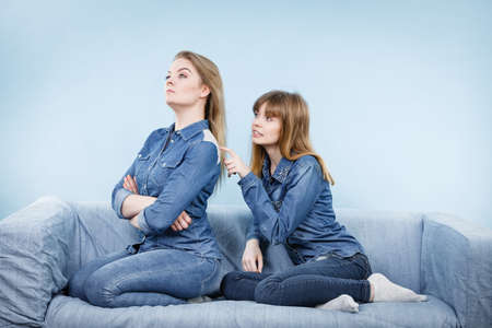Two women after being mad at each other one feeling offended. Female being pained.の写真素材