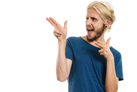 Concept of joy, positive emotion. Happy joyful young man, stylish bearded male smiling laughing, pointing with fingers, isolated on whiteの写真素材